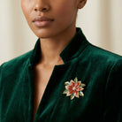 Woman in a velvet green top wearing a Poinsettia Brooch