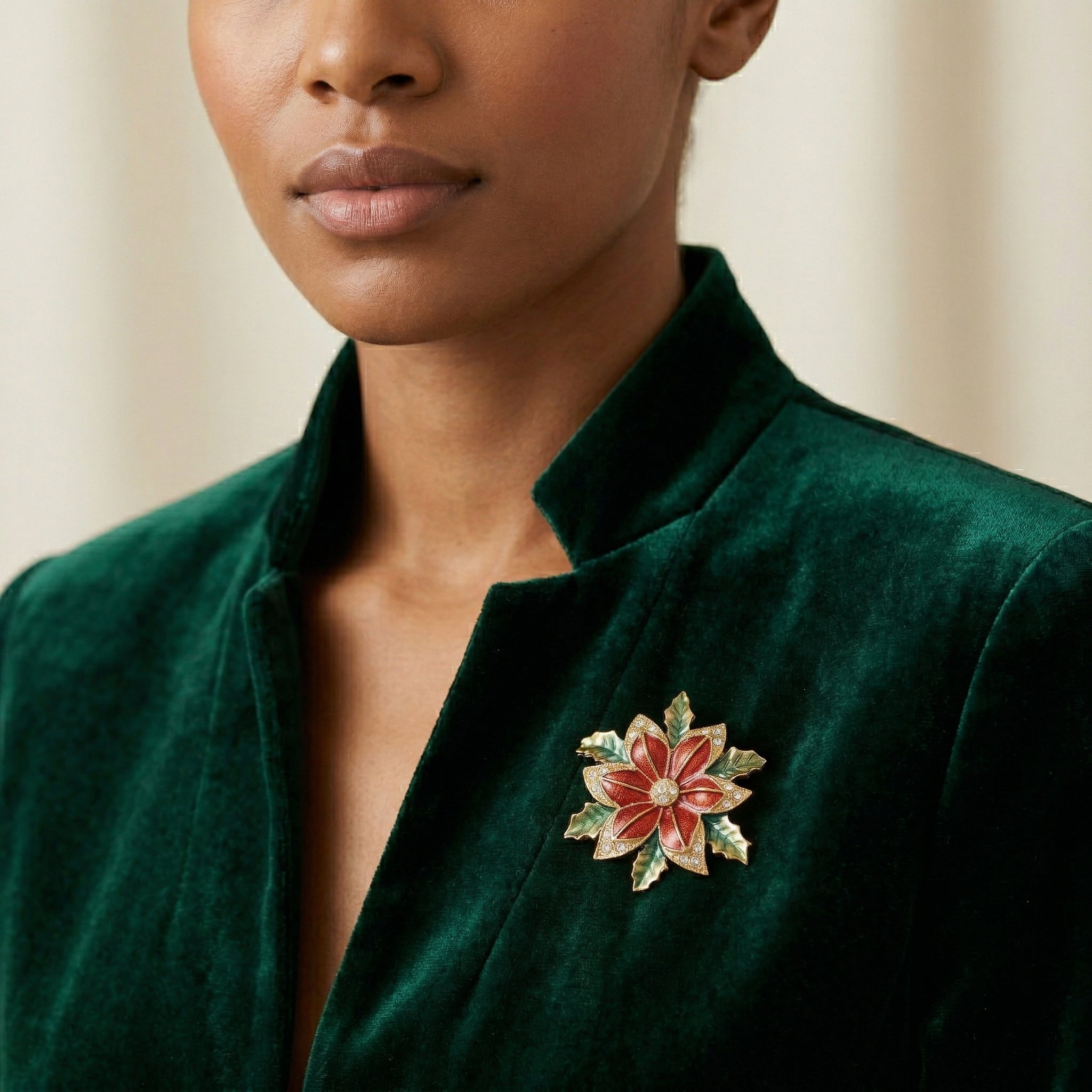 Woman in a velvet green top wearing a Poinsettia Brooch
