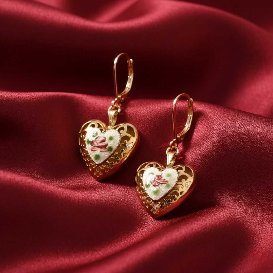 Heart-shaped earrings with floral design on a red fabric background