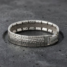 Silver Hammered Link Mesh Bracelet resting in a dark stone surface