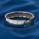 Silver bracelet on a blue fabric background