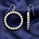 Faux White Pearl Hoop Wire Earrings on dark blue fabric