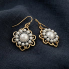 Gold & Silver Tone Filigree Pearl Drop Earrings on dark linen fabric