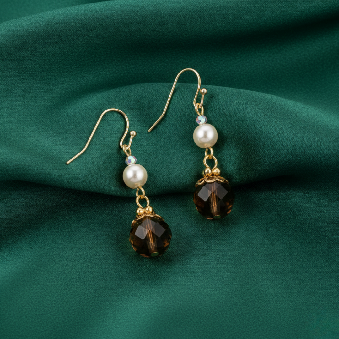 Autumn Glow Smoked Topaz & Peach Pearl Dangling Earring on a green fabric