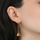 Close-up of an ear wearing Lux Multi-Colored Glass Bead Dangling Earrings