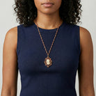 Woman in a navy blue sleeveless top wearing a Yellow Topaz Crystal Carnelian Copper Cameo Floral Pendant Necklace