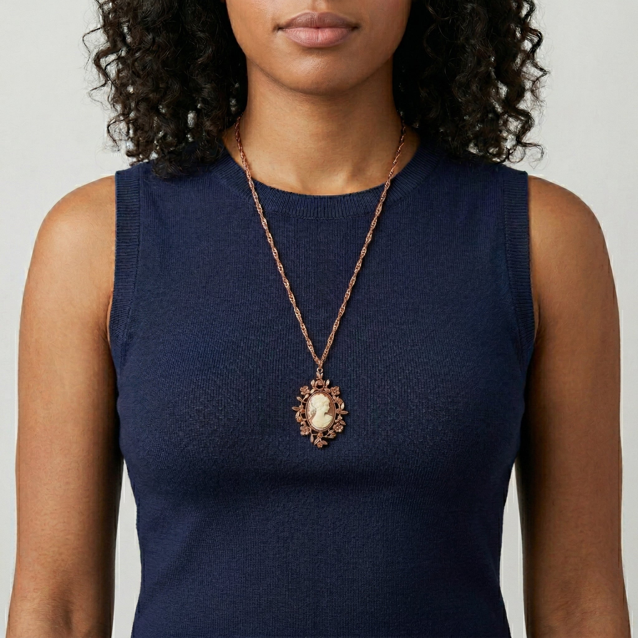 Woman in a navy blue sleeveless top wearing a Yellow Topaz Crystal Carnelian Copper Cameo Floral Pendant Necklace