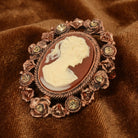 Floral & Topaz Crystal Cameo Brooch resting on brown fabric