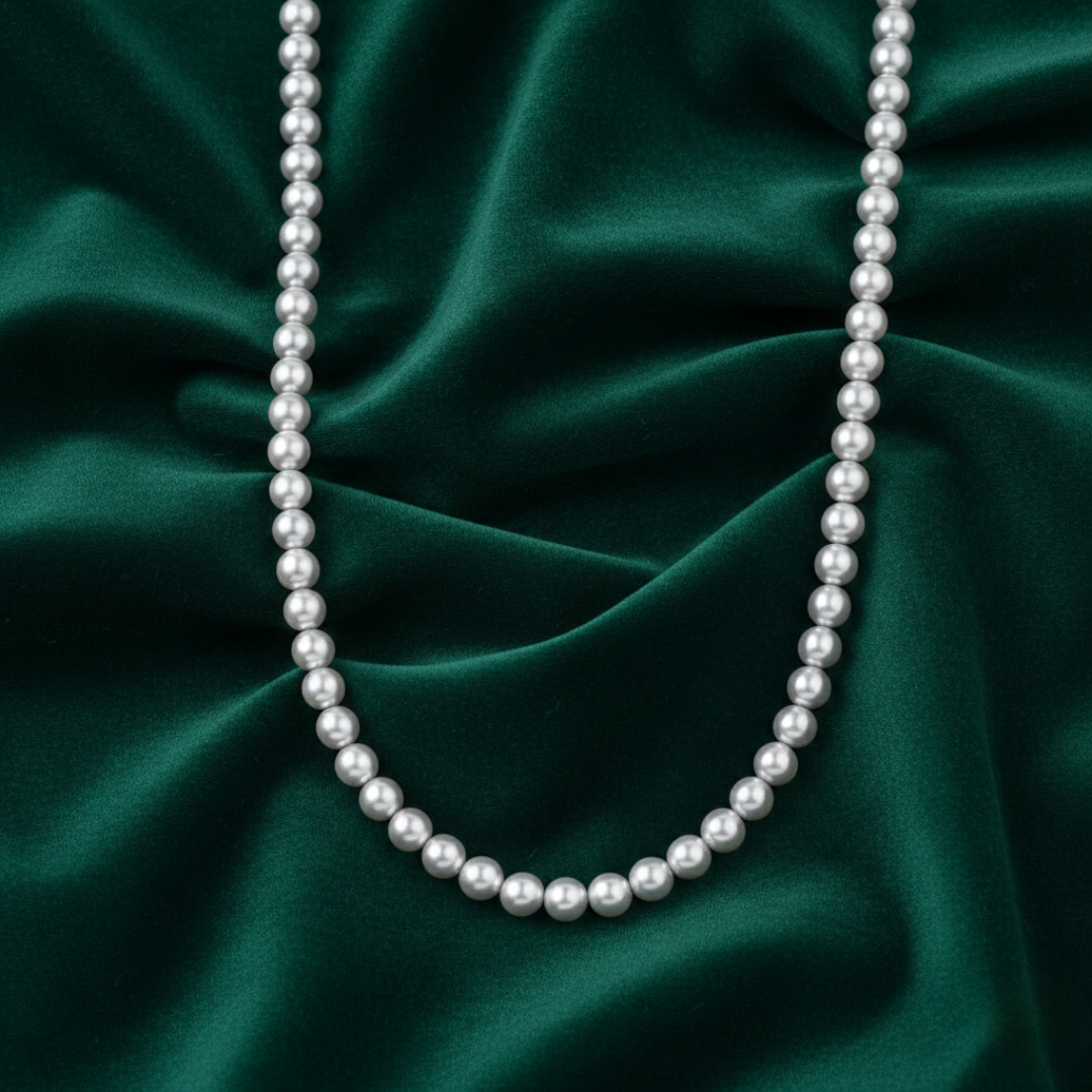 Pearl necklace on a green satin background