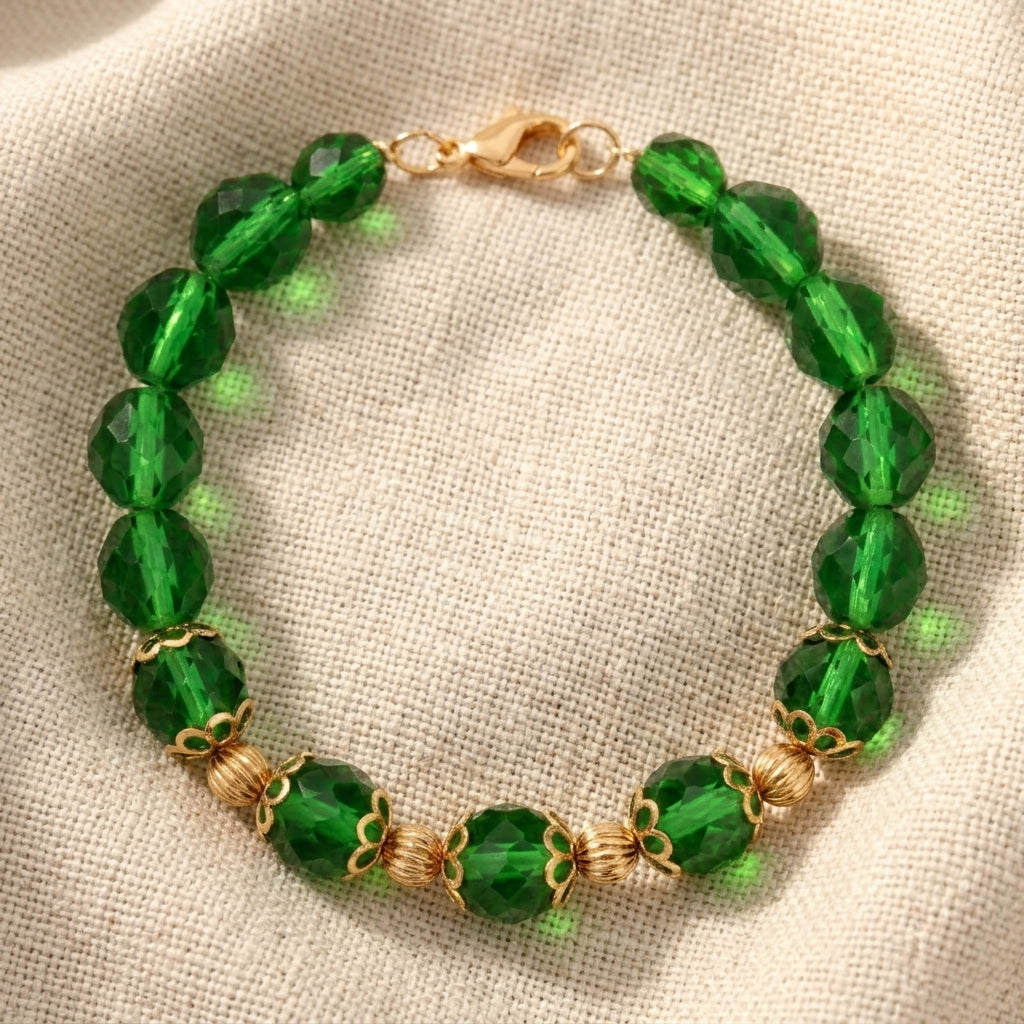 Green fire-polished beaded bracelet resting on linen fabric