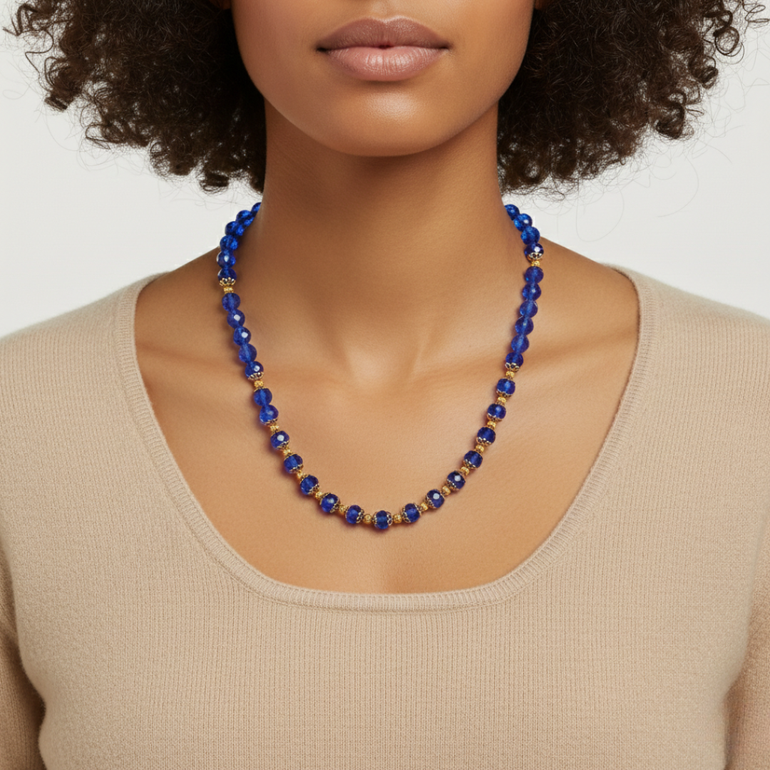Woman wearing a blue beaded necklace against a neutral background