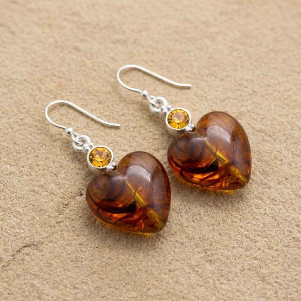 Tortoise Heart Baubles & Crystals Drop Earrings on a beige stone surface
