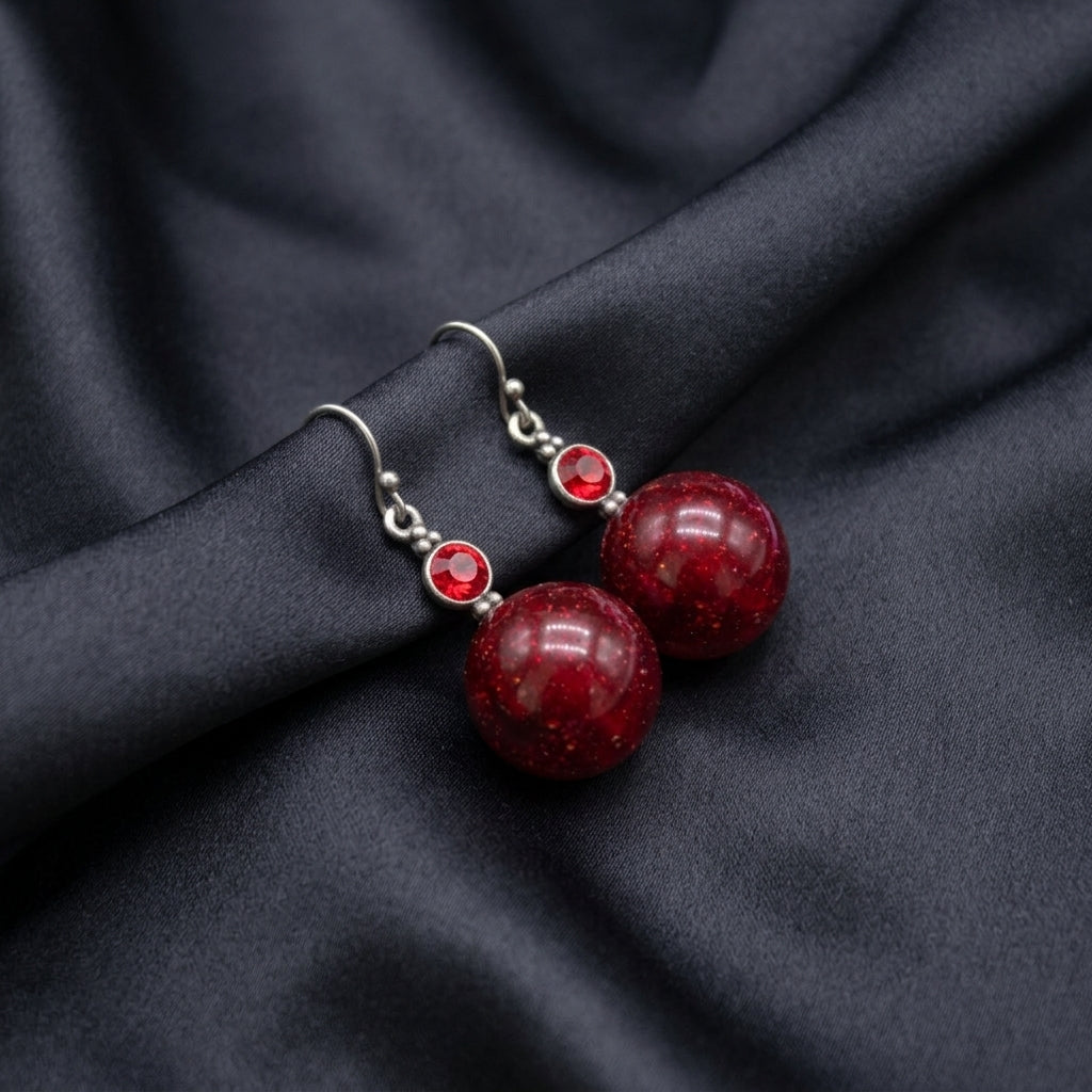 Red Sparkling Baubles & Siam Crystals Drop Earrings on dark satin fabric