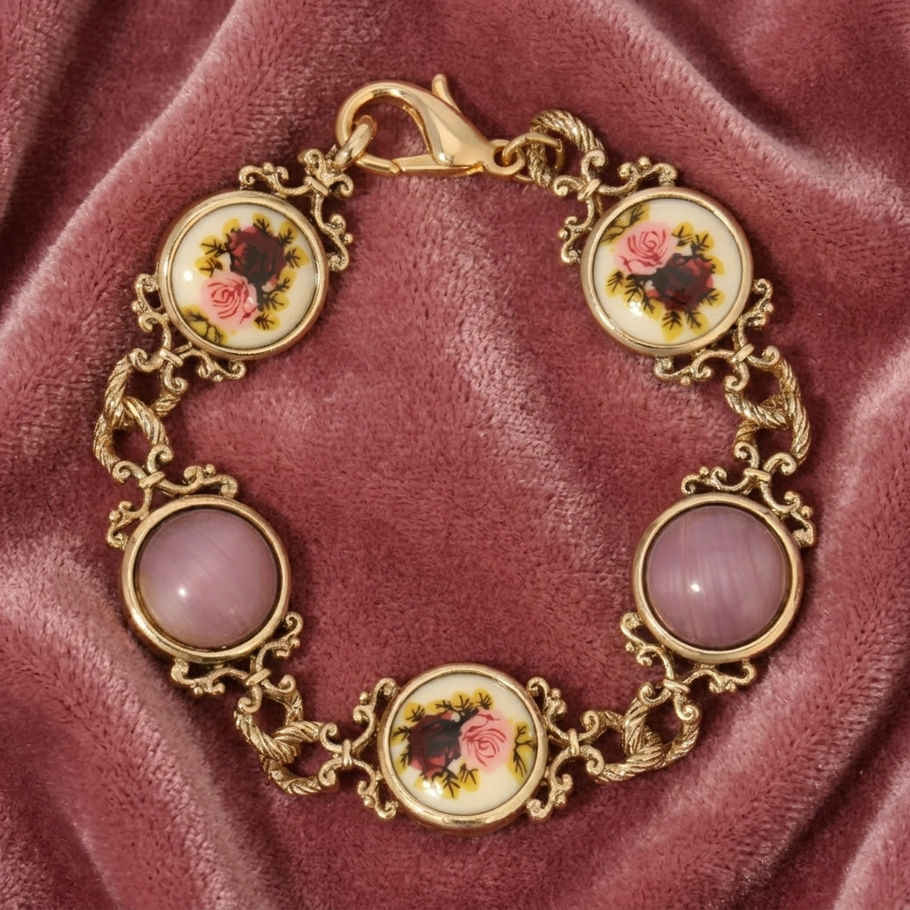 Decorative bracelet with floral and pink cabochon stone designs on a maroon fabric background