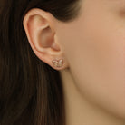Close up of a woman wearing Petite Monarch Butterfly Gold Tone Stud Earrings