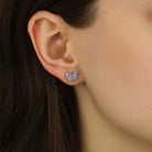 Close up of a woman wearing Petite Monarch Butterfly Silver Tone Stud Earrings