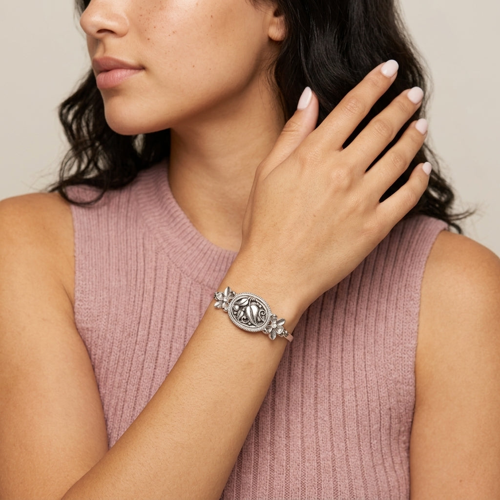 Woman in a light purple top wearing a silver tone Spring Garden Bloom Bracelet