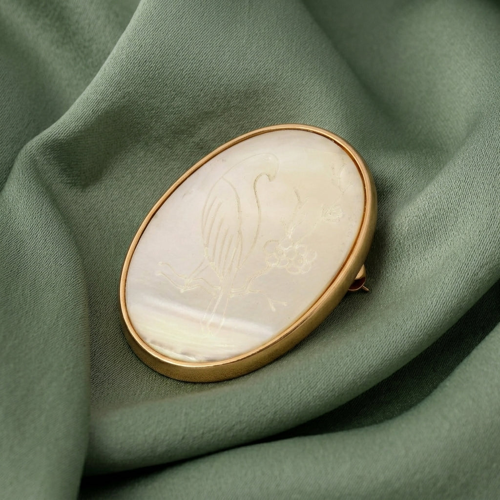 Brooch with gold frame on green fabric