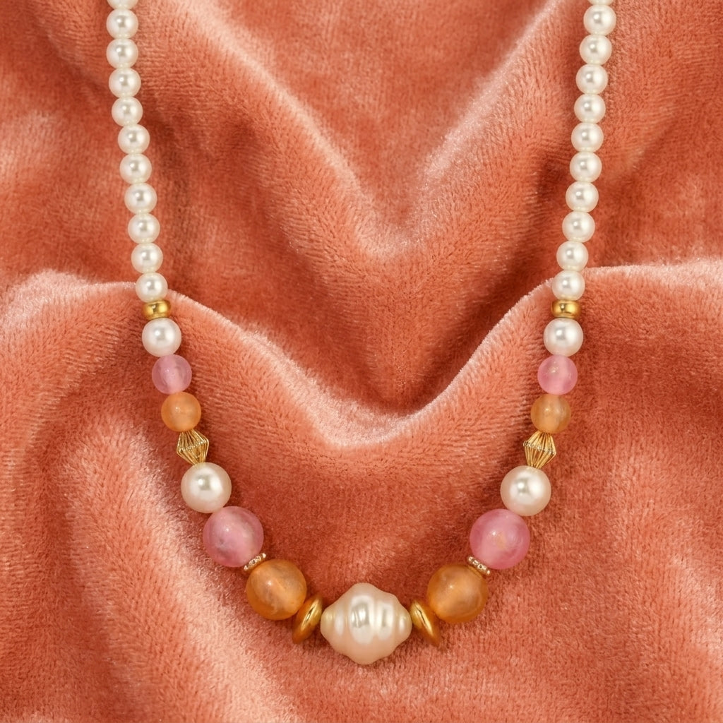 Necklace with pearls and colorful beads on a pink fabric background