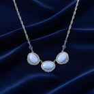Necklace with blue stones on a dark blue fabric background