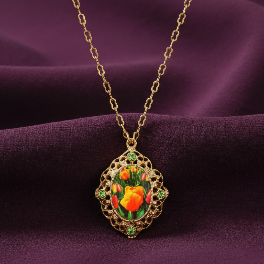 Gold necklace with a floral pendant on a purple fabric background