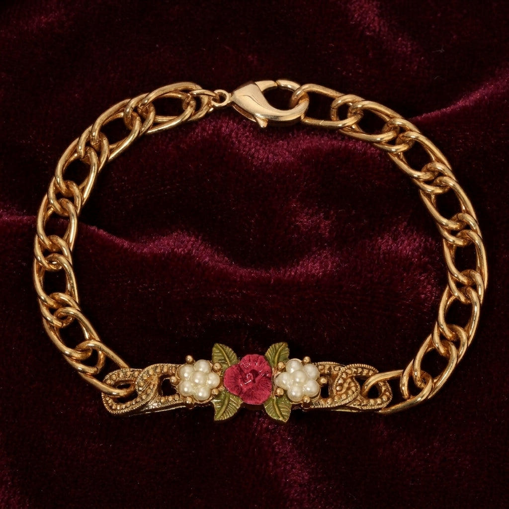 Gold chain bracelet with floral design on a red velvet background