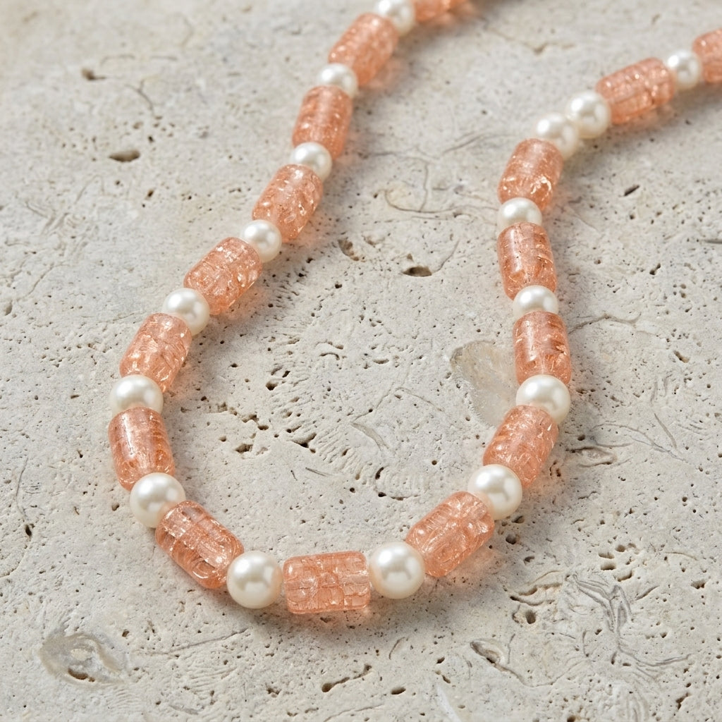 Peach Cracked Glass & White Faux Pearl Necklace 15" + 3" Extension displayed on a light beige stone surface.