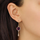 Close up of a woman wearing Golden Amethyst Purple Channel Crystal Pear Drop Earrings