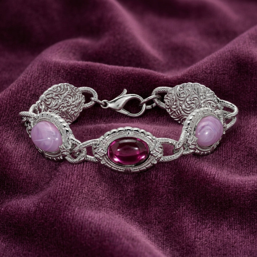 Silver tone and purple stone bracelet resting on purple fabric 