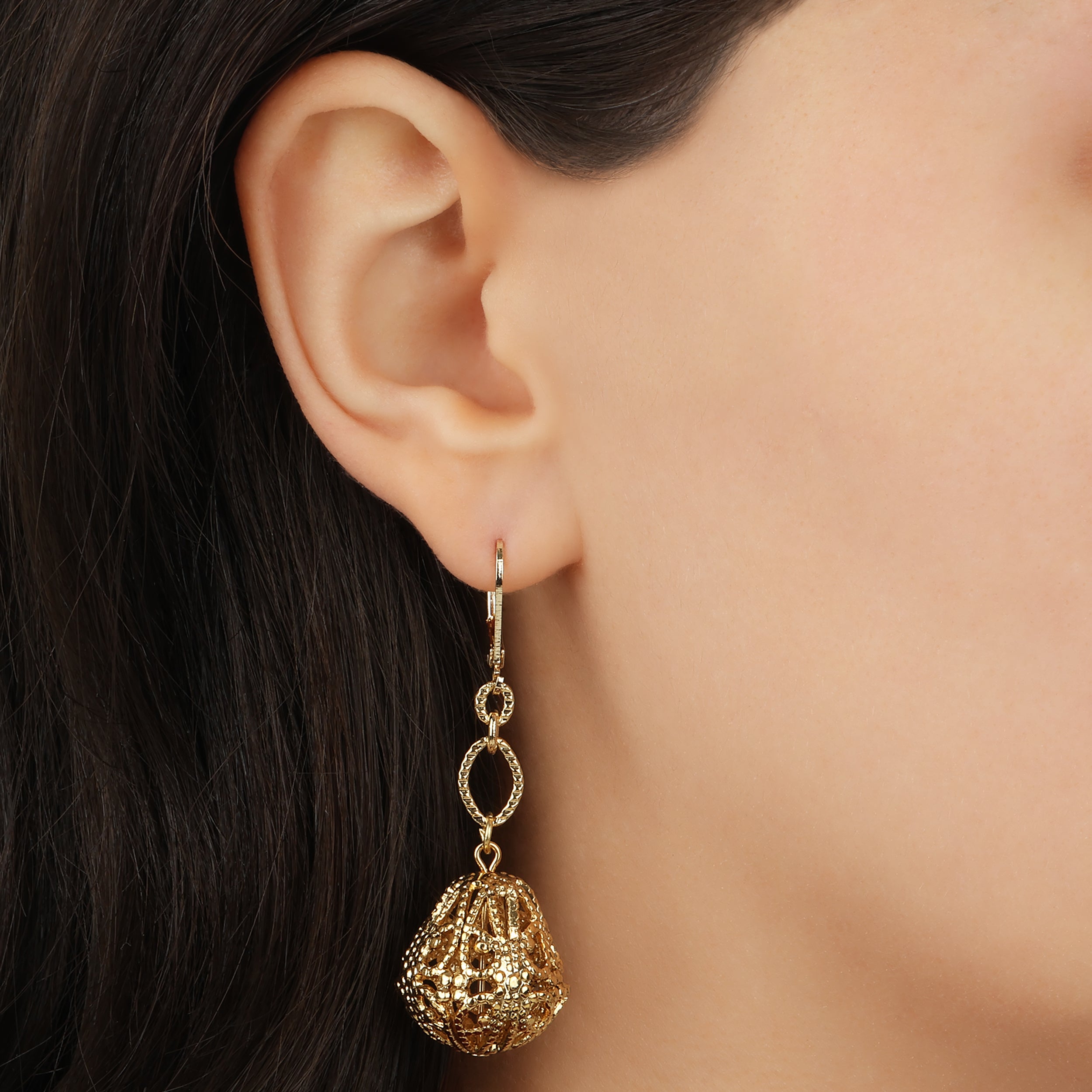 Close up of a woman wearing Golden Bell Shaped Filigree Drop & Dangle Earrings