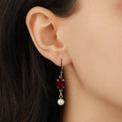 Close up of a woman wearing Oval Siam Red Crystal & Pearl Bead Drop & Dangle Earrings