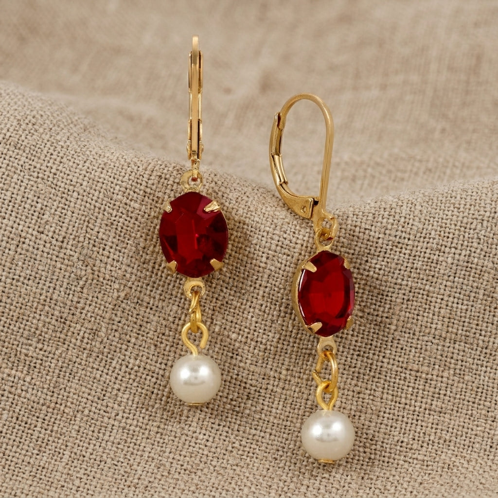 Oval Siam Red Crystal & Pearl Bead Drop & Dangle Earrings resting on beige linen