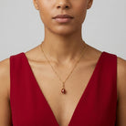 Trellis Red Enamel Crystal Egg Drop Pendant Necklace 18" worn by a woman in a ruby red dress