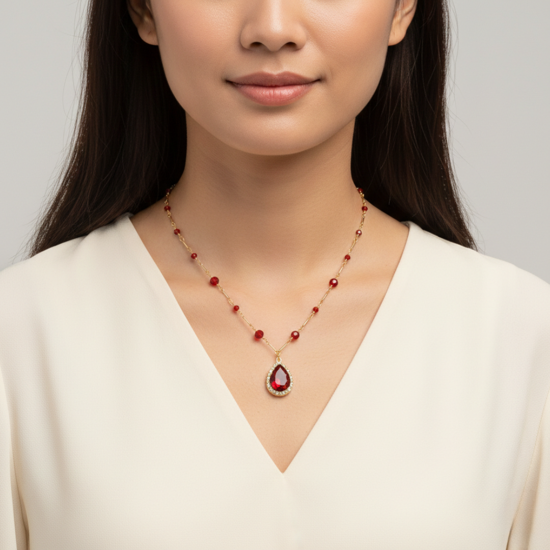 Woman wearing a gold-dipped Siam Red beaded necklace.