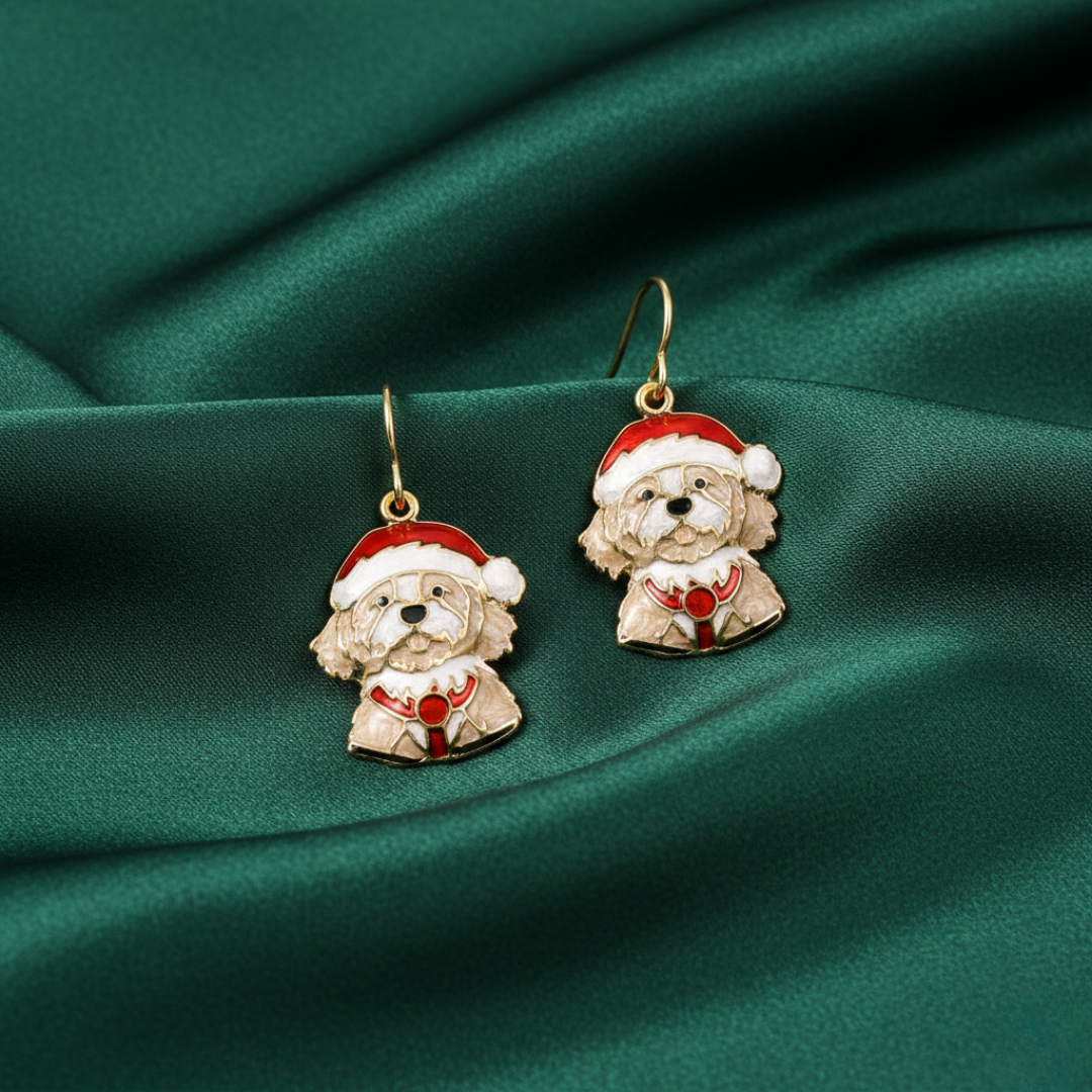 Dog-shaped earrings with Santa hats on a green fabric background