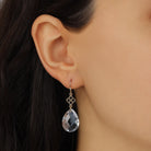 Close up of a woman wearing Faceted Briolette Clear Crystal Teardrop Earrings