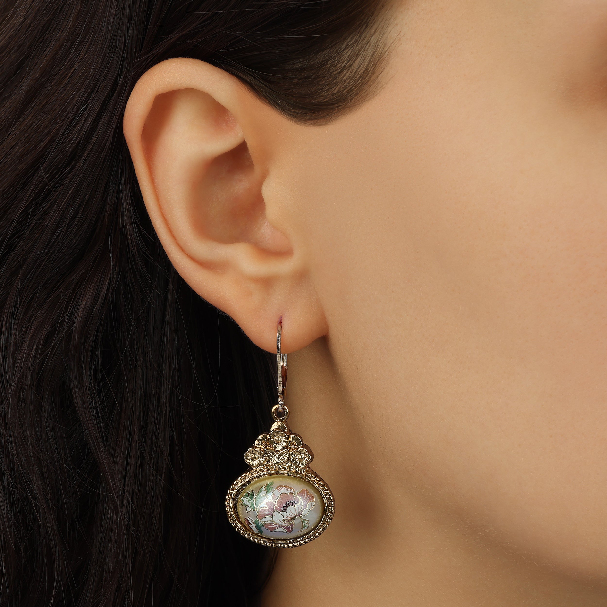 Golden Antique Oval Faux Pearl & Pink Floral Drop Earrings worn by a model with the shot framed close to her ear.