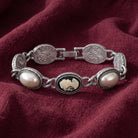 Vintage Style Black Cameo Stone & Grey Faux Pearl Link Bracelet displayed on draped burgundy fabric.