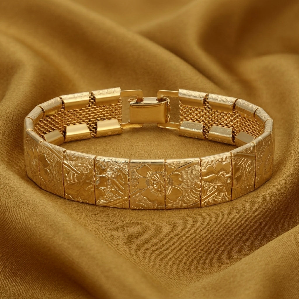 Gold bracelet with floral patterns on a brown fabric background