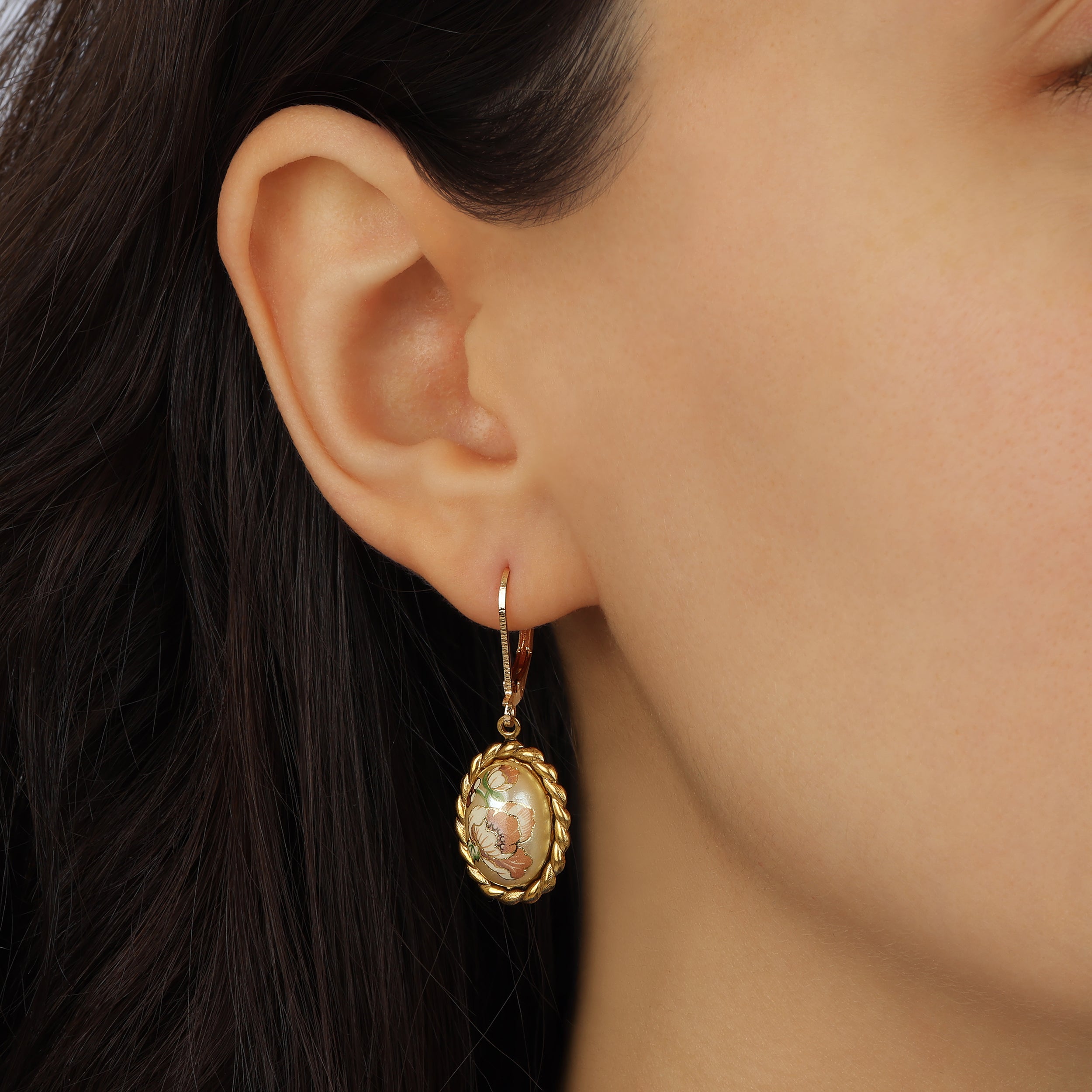 Close up of a female model wearing Pink Floral Oval Faux Pearl Decal Drop Earrings