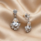 Oval & Round Austrian Crystal Vintage Post Stud Earrings resting on champagne silk