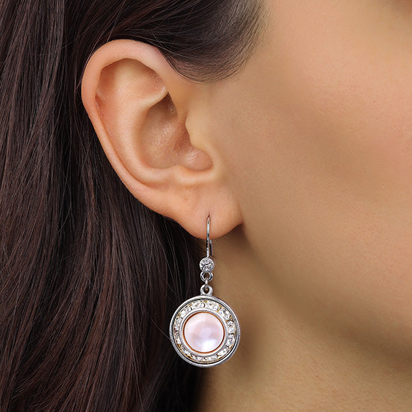 Close shot of a model wearing our Silver Mother Of Pearl & Clear Crystal Round Earrings