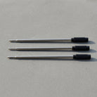 Set Of 3 Pen Black Refill Ink Cartridges resting on concrete surface