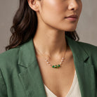 A woman in a green blazer wearing an Emerald Green Glass Beads & Faux Pearl Chain Necklace 15" + 3" Extension