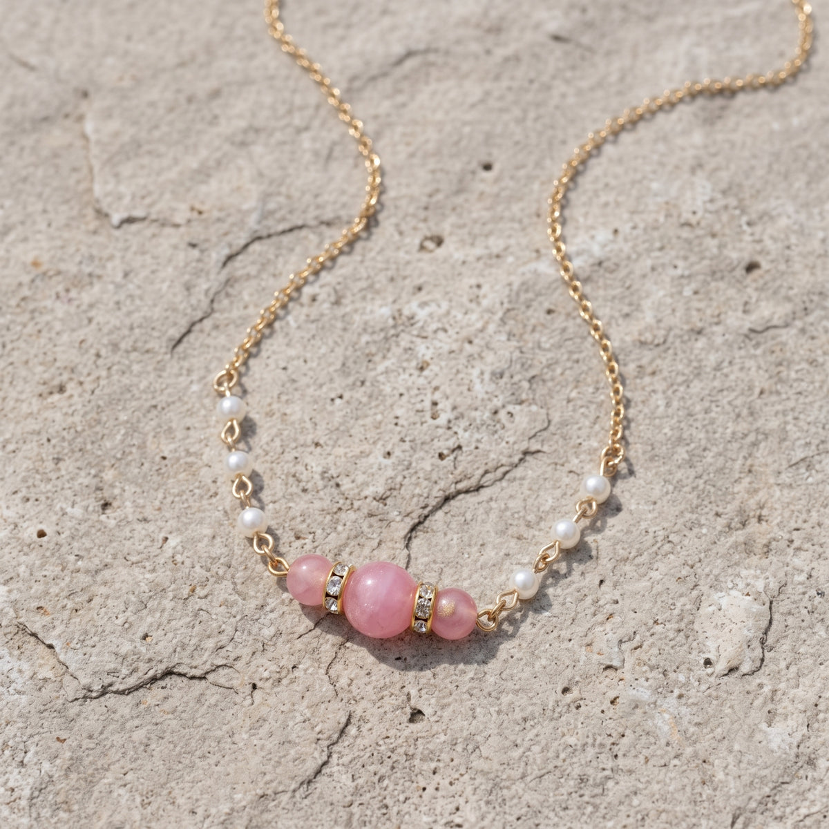Pink Peppermint Beaded & Faux Pearl Chain Necklace 15" + 3" Extension, displayed on a textured light gray stone surface.
