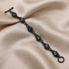 Bracelet with blue gemstones on a beige fabric background
