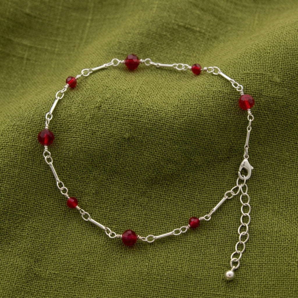 Red Beaded Crystal Chain Anklet 9" +  1.5" Extension resting on green linen fabric