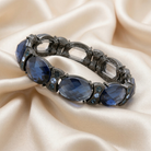 Decorative bracelet with blue stones on a beige fabric background