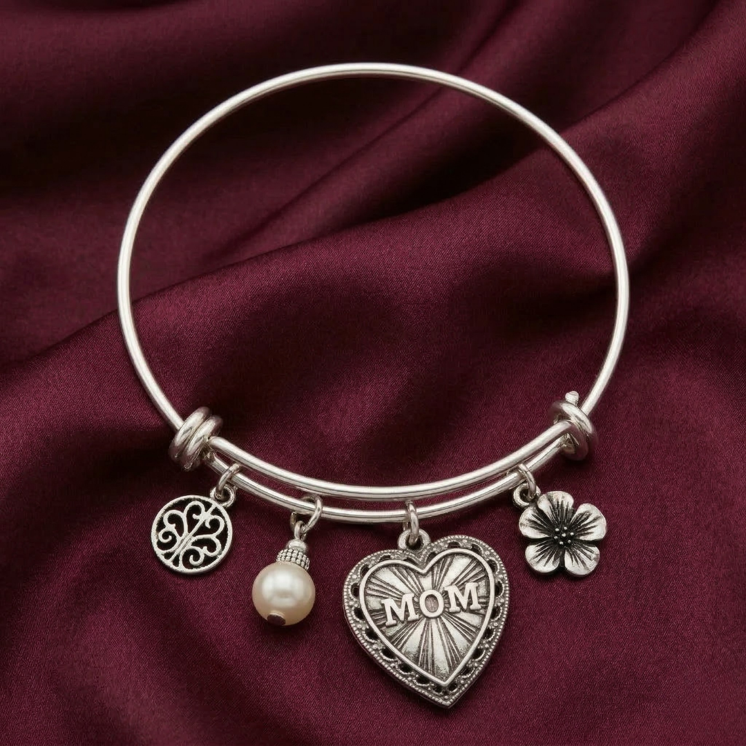 Silver bracelet with Mother's Day charms on a maroon fabric background