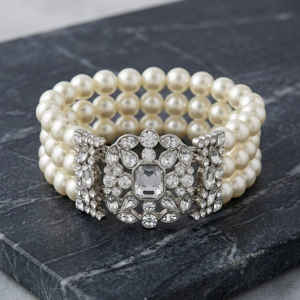 Pearl bracelet with clear crystal accents on a dark stone surface